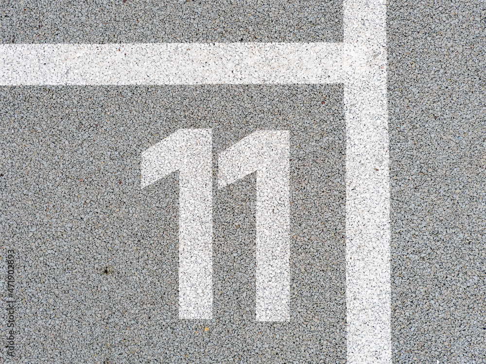 Number eleven painted on soft rubber surface. Eleventh place. Jumping hopscotch
