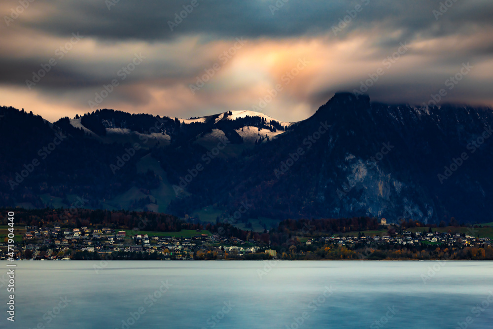 Clouds over the snow-capped mountains on Lake Thun