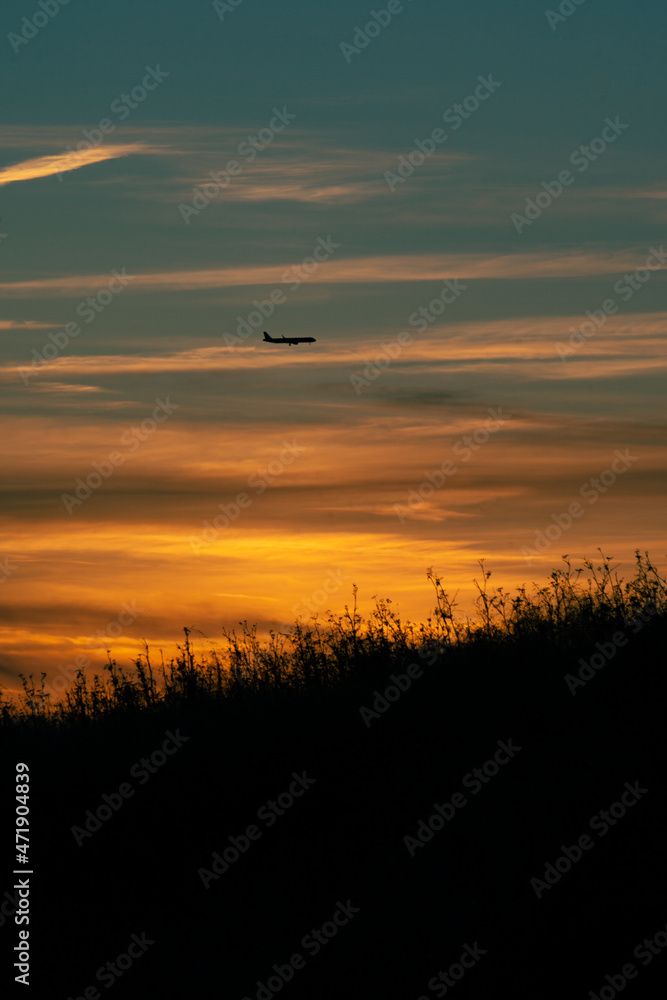 Silhouette of airplane against sunset Silhouette of airplane against sunset