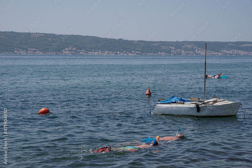 People relaxing and snorkeling in the ocean in Croatia 
