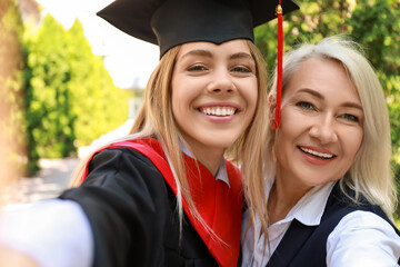 Happy young woman with her mother on graduation day
