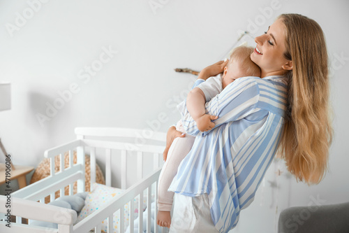 Young mother holding her cu...