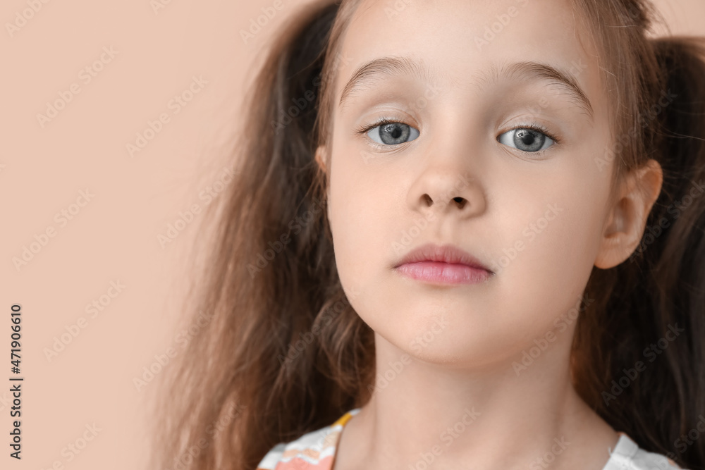 Portrait of cute little girl with ponytails on beige background, closeup Portrait of cute little girl with ponytails on beige background, closeup