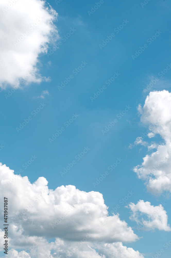 white clouds in a blue sky, in vertical format white clouds in a blue sky, in vertical format