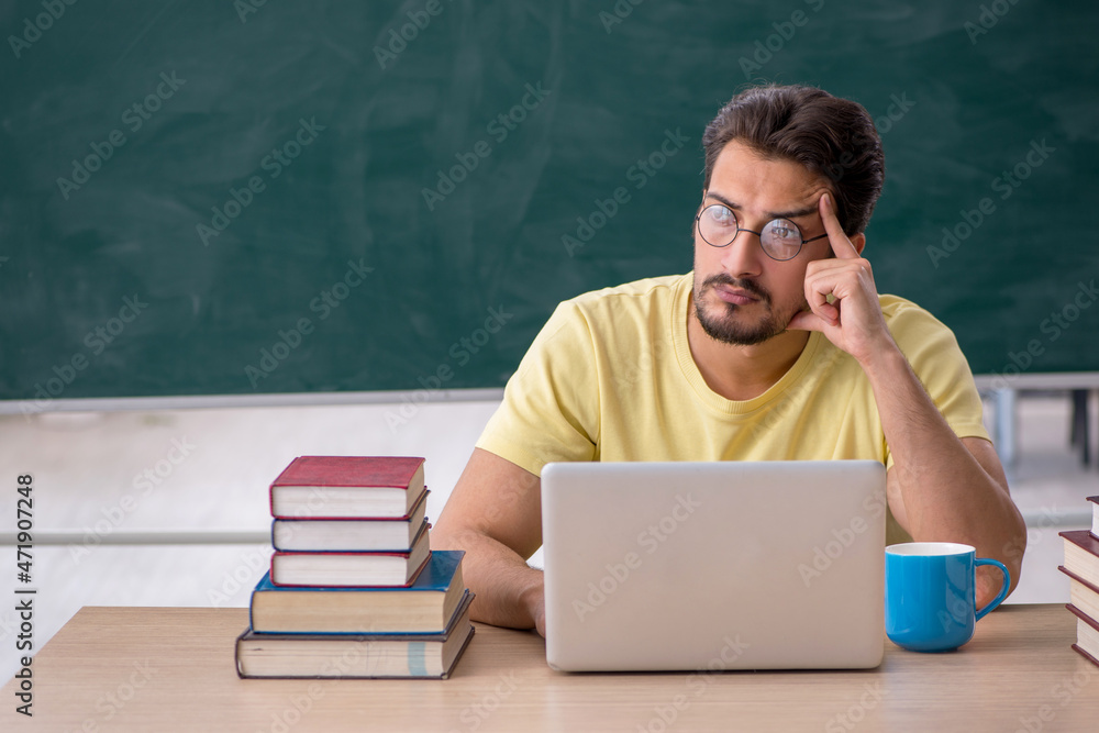 Young male student preparing for exams in the classroom Young male student preparing for exams in the classroom