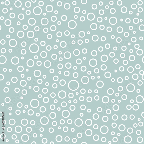 Seamless vector background with random white circles. Abstract ornament. Dotted abstract pattern