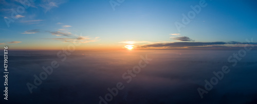 Sunrise over thick autumn fog. Panorama over the clouds in the morning.