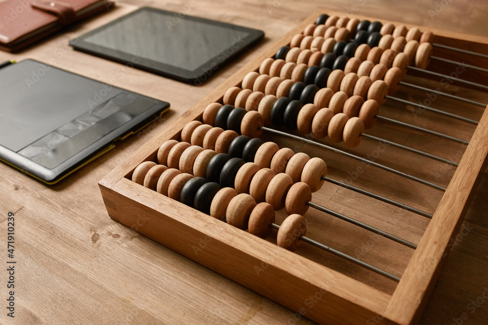 computer tablet, graphic tablet and wooden abacus on the table computer tablet, graphic tablet and wooden abacus on the table