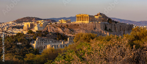 The Acropolis of Athens, Greece, with the Parthenon Temple atop the hill during sunset.