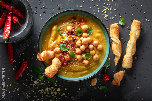 Creamy chickpea soup with grissini and sesame seeds. photo