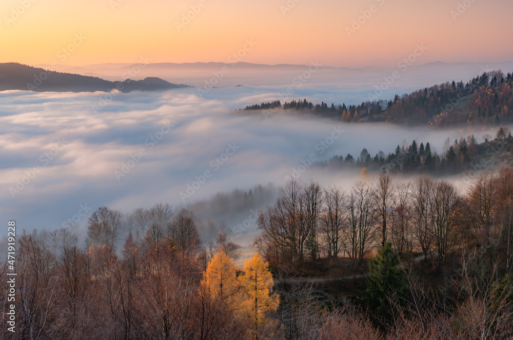 Misty autumn mountains landscape in the morning, Poland, Beskidy mountains and Tatra mountains in the background