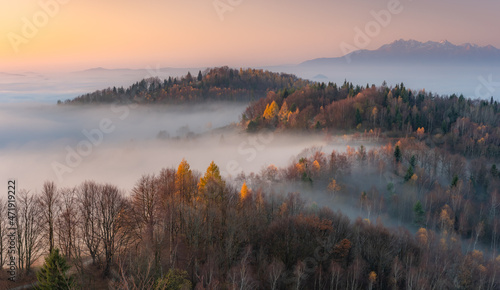 Fototapeta Naklejka Na Ścianę i Meble -  Misty autumn mountains landscape in the morning, Poland, Beskidy mountains and Tatra mountains in the background