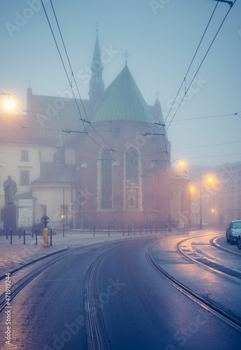 Picturesque old town Franciszkanska street and St Francis church on foggy morning, Krakow, Poland photo