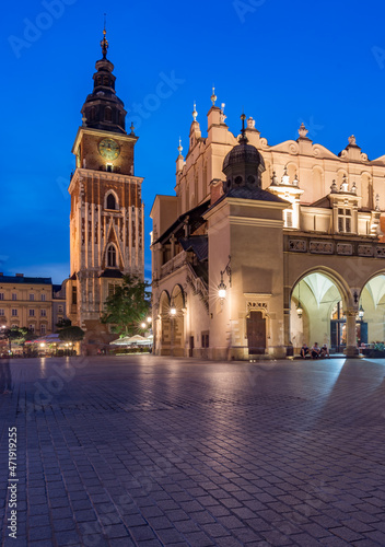 Main market square in Krakow, Poland, Cloth Hall and Town Hall tower in the evening