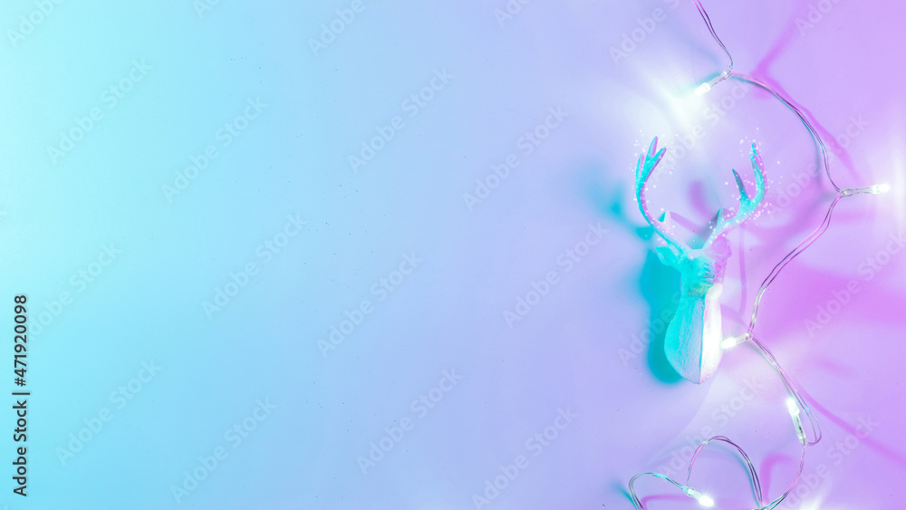 Deer lights neon Christmas winter background. Minimal abstract xmas reindeer. Holiday decoration bauble ball on neon gradient backdrop. Minimal new year card. Deer lights neon Christmas winter background. Minimal abstract xmas reindeer. Holiday decoration bauble ball on neon gradient backdrop. Minimal new year card.