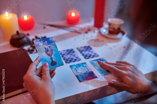 Photography Experienced fortune-teller reading cards laid out on the divination table