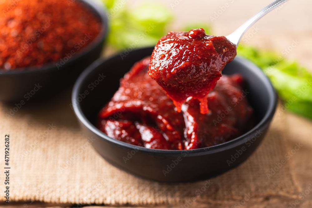 Korean gochujang (red chili paste), spicy and sweet fermented condiment in Korean food Korean gochujang (red chili paste), spicy and sweet fermented condiment in Korean food