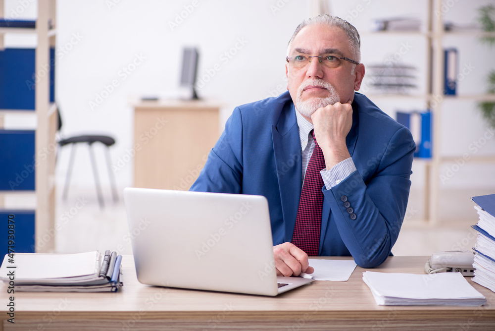 Old male employee and too much work in the office Old male employee and too much work in the office