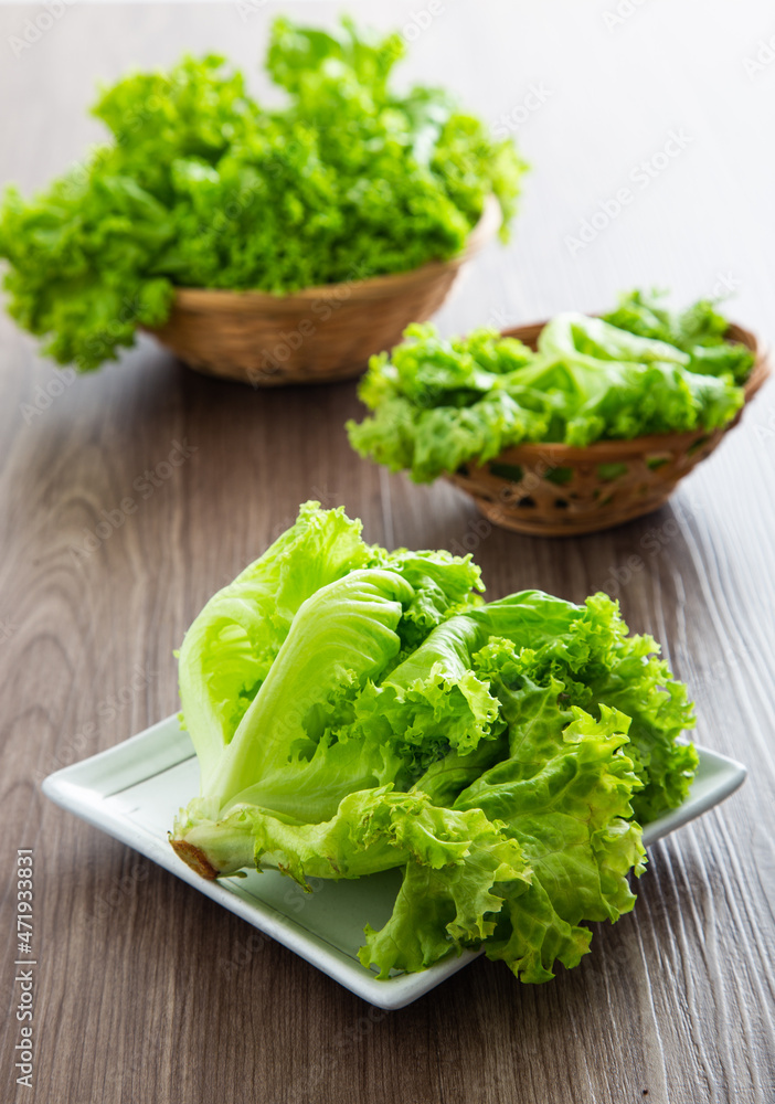 Fresh lettuce vegetable on a wooden table Fresh lettuce vegetable on a wooden table