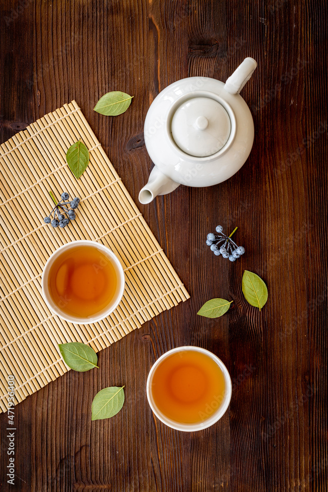 Asian tea set with white teapot and two cups, top view