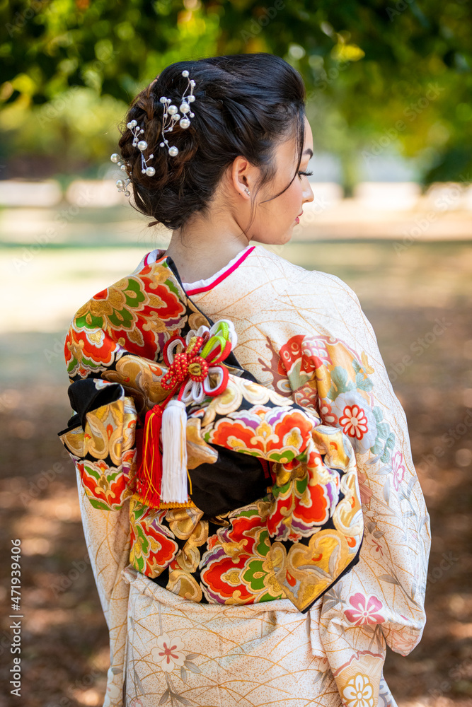 Rear view of woman wearing kimono standing in park Rear view of woman wearing kimono standing in park