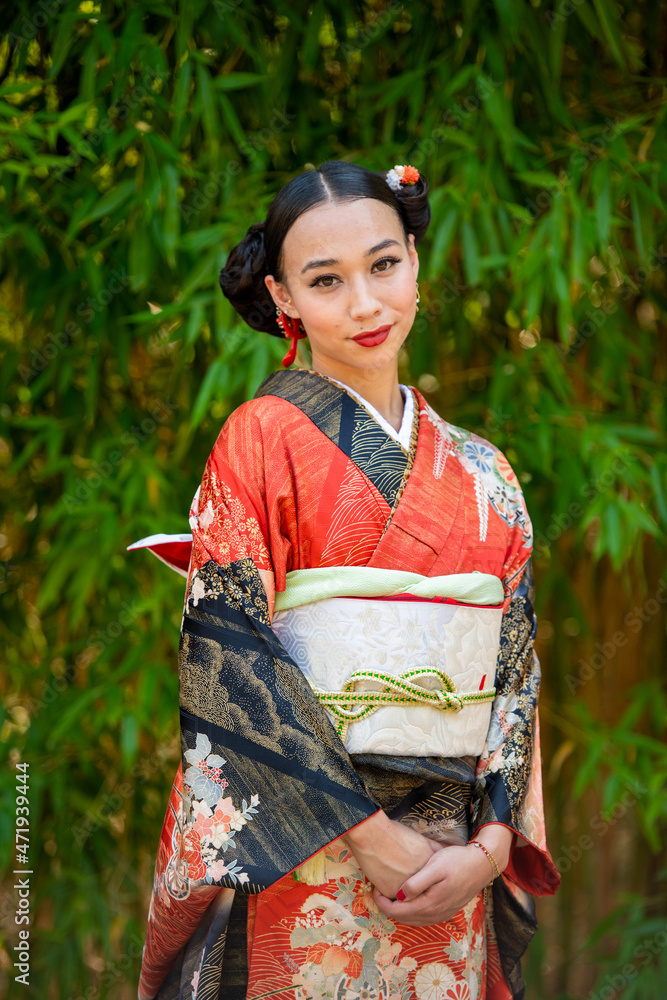 Portrait of smiling woman wearing kimono standing in park Portrait of smiling woman wearing kimono standing in park