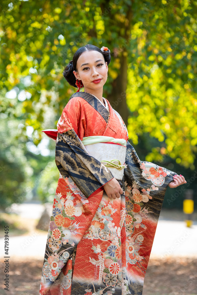 Portrait of smiling woman wearing kimono in park Portrait of smiling woman wearing kimono in park