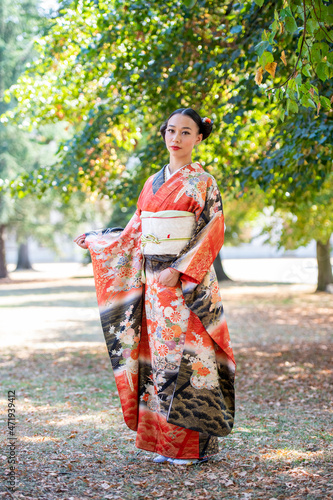 Woman in kimono posing in park