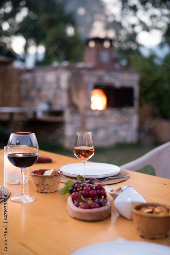 Wine and grapes on table in garden Wine and grapes on table in garden
