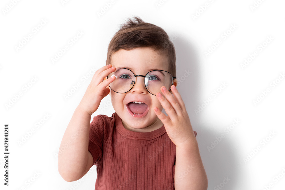 Portrait of funny boy smiles with big black glasses on a white background 