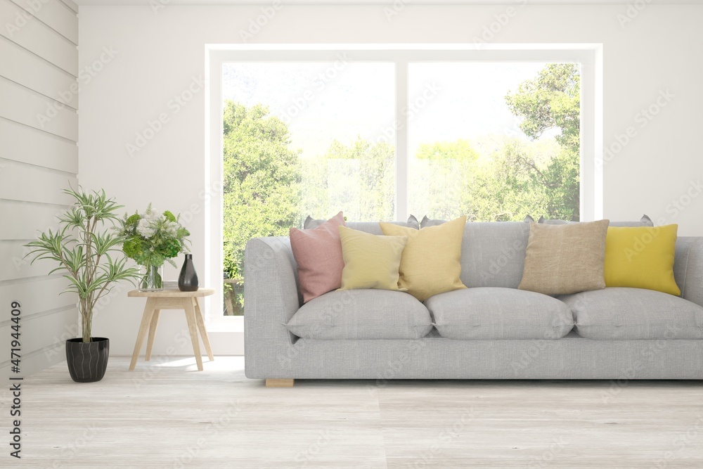 Fototapeta premium White living room with sofa and summer landscape in window. Scandinavian interior design. 3D illustration