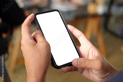 Close up view of man hands holding smart phone with empty display.