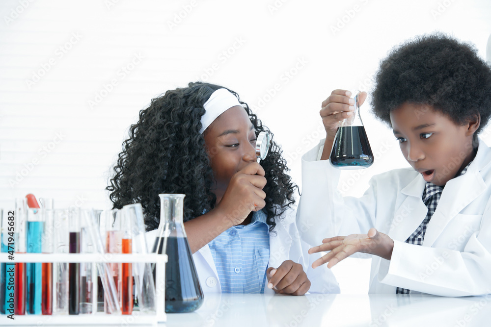 Little African kids learning chemistry and doing chemical science ...
