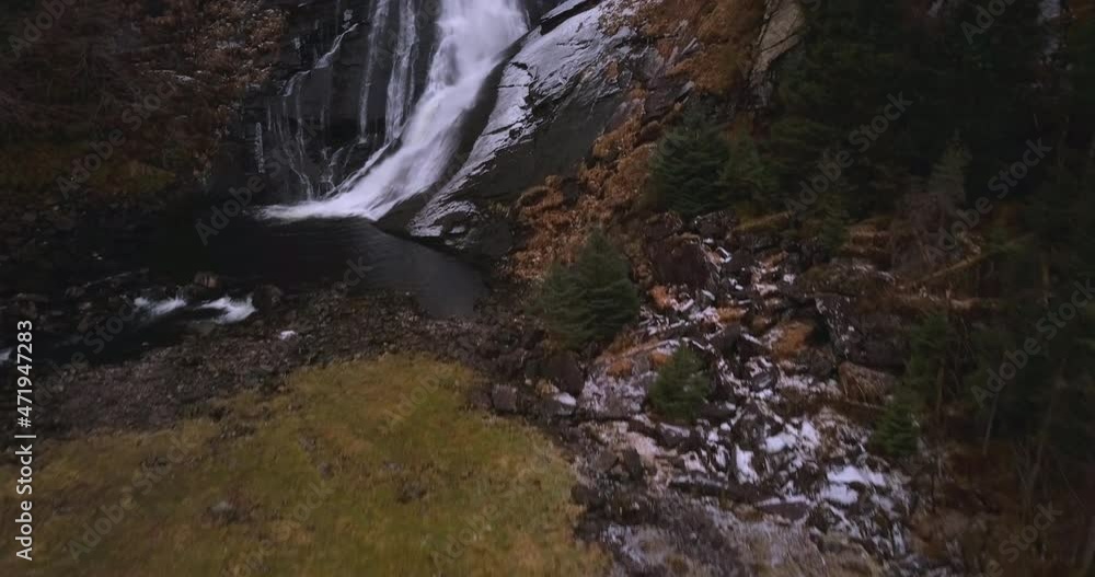 Picturesque waterfall is revealed in cinematic, ascending aerial footage in autumn colors in Norway. Starts from the bottom and we follow up until over the top and revealing the mountains at the back. Picturesque waterfall is revealed in cinematic, ascending aerial footage in autumn colors in Norway. Starts from the bottom and we follow up until over the top and revealing the mountains at the back.