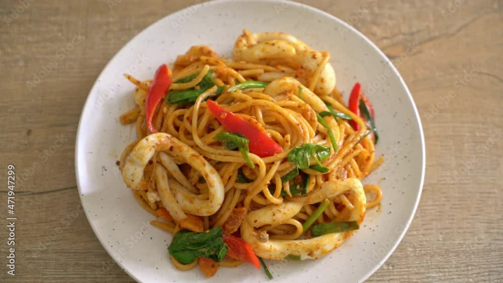 stir-fried spaghetti with salted egg and squid - fusion food style stir-fried spaghetti with salted egg and squid - fusion food style