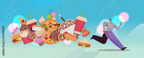 man running away from junk food assortment of fast food unhealthy nutrition junkfood addiction concept horizontal