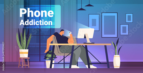 addicted man using digital gadget guy active in social networks at workplace digital addiction concept