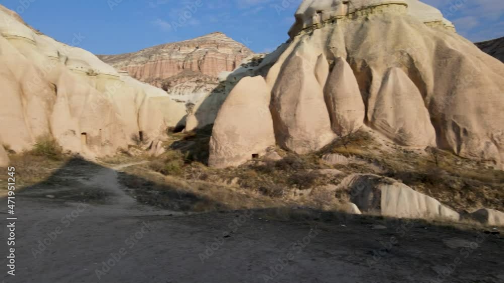 Volcanic ridge in Goreme, Cappadocia, and rocks with ancient heritage in Goreme National Park at autumn sunny day, Aerial drone view