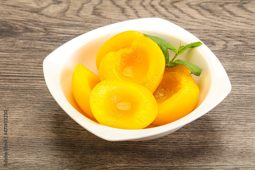 Sweet ripe canned peaches with mint