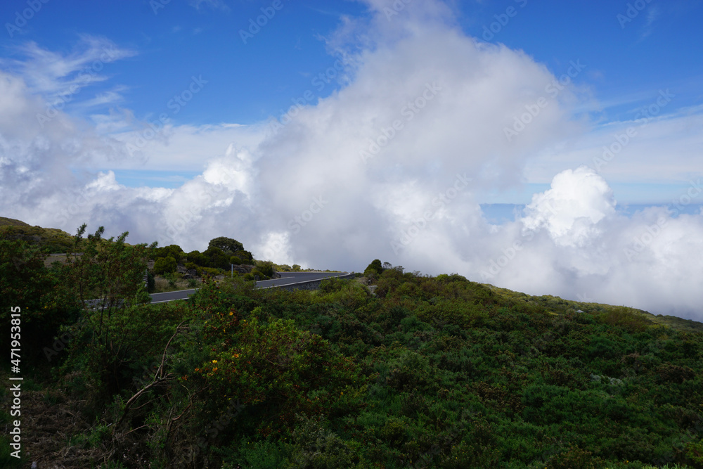clouds over the mountains, the highway and the sea on the tropical island of la réunion france