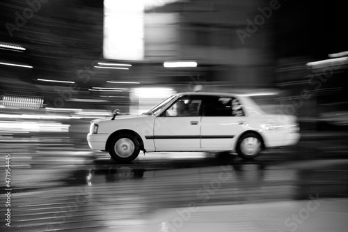 Taxi driving fast in the city at night