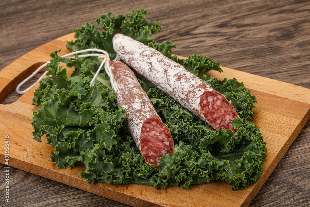 Spanish Fuet sausage with salad leaves Spanish Fuet sausage with salad leaves