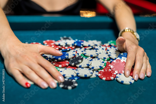 female player checking how much winning at casino poker game