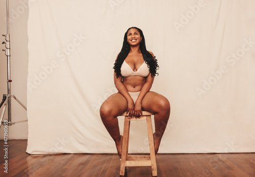Body positive woman smiling cheerfully in a studio