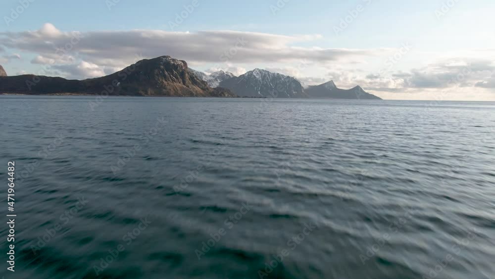 Drone flies low over sea towards mountains at lofoten islan in northern Norway. Drone flies low over sea towards mountains at lofoten islan in northern Norway.