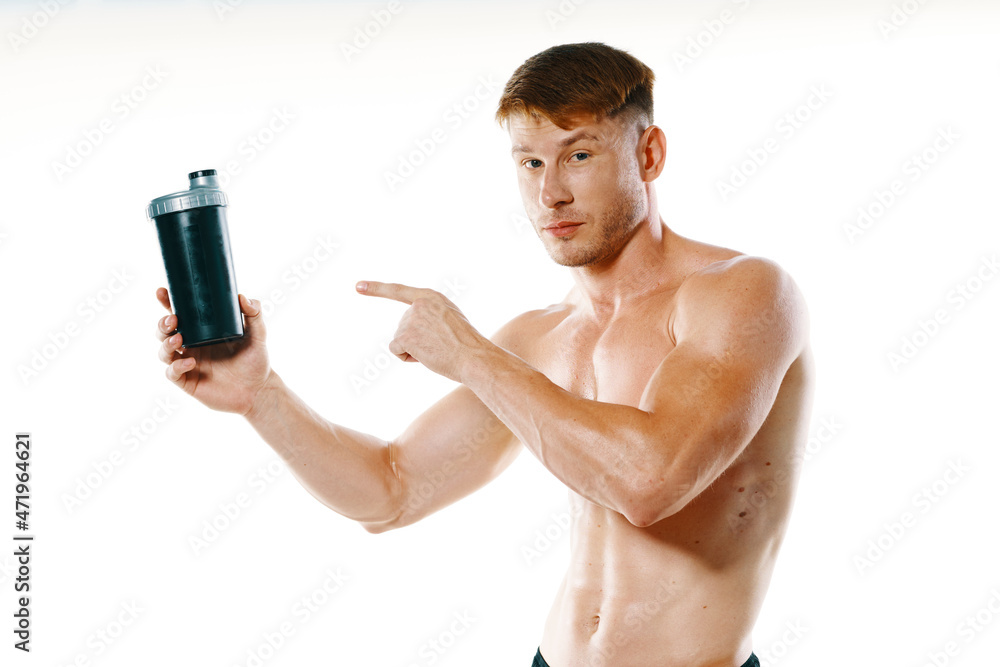 Fototapeta premium athletic man with a pumped-up torso drink bottle sportspit