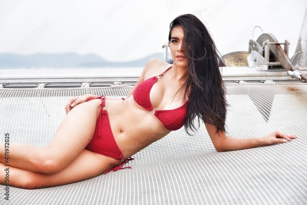 portrait sexy asia woman wear bikini on the yacht
