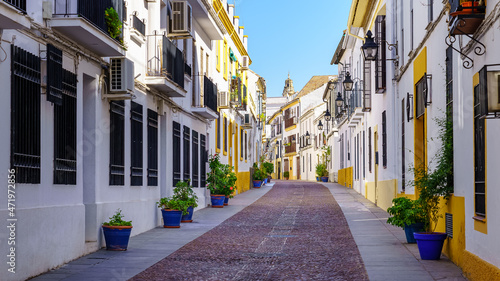 Narrow alley with typical Andalusian white houses, Córdoba Spain.