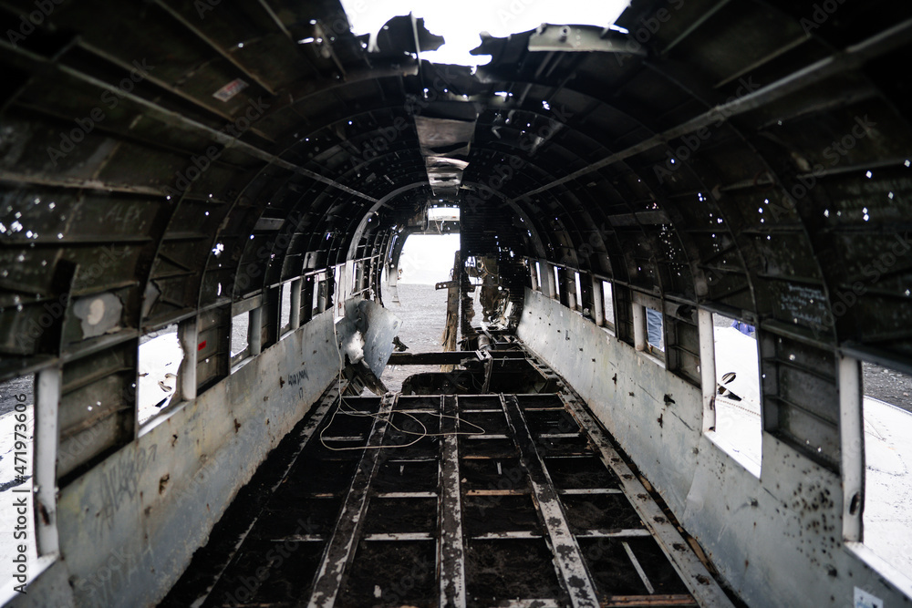 Naklejka premium The wreckage of an abandoned DC 3 plane on a black ocean beach in Iceland. Popular attractions in Iceland. Solheimasandur plane crash, Black sand Beach 