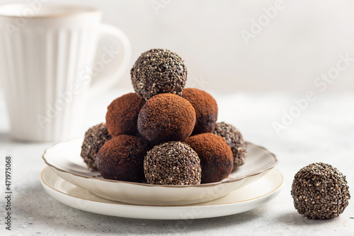 Foto vegan energy bliss balls with chia seeds, cocoa powder and cup of hot drink